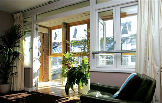 The entire south facing aspect of the BedZED apartments uses winter gardens to let light and heat in The entire south facing aspect of the BedZED apartments uses winter gardens to let light and heat in