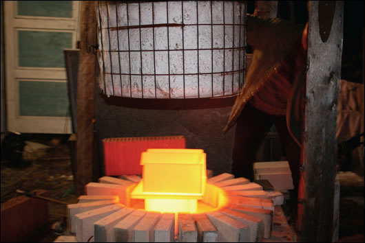 (above) the schamotte fire bricks of the kachelofen being fired; (below) the floor build up includes Fermacell slabs suspended on pedestals, and 160mm of Rockwool insulation (above) the schamotte fire bricks of the kachelofen being fired; (below) the floor build up includes Fermacell slabs suspended on pedestals, and 160mm of Rockwool insulation