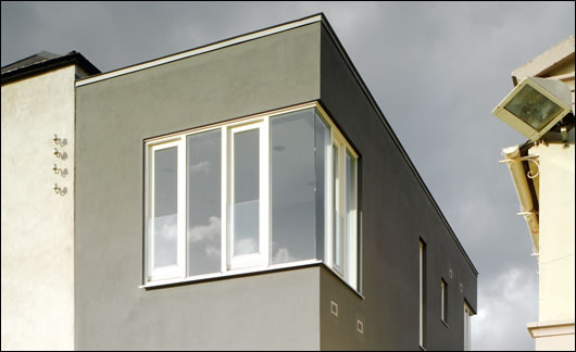 The new east extension was painted black in order to visually recede and draw attention to the surrounding historic buildings The new east extension was painted black in order to visually recede and draw attention to the surrounding historic buildings