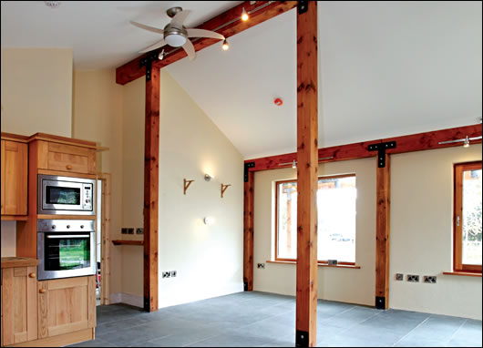 the main post and beam structure, seen here in the kitchen-cum-living room, is locally sourced douglas fir the main post and beam structure, seen here in the kitchen-cum-living room, is locally sourced douglas fir