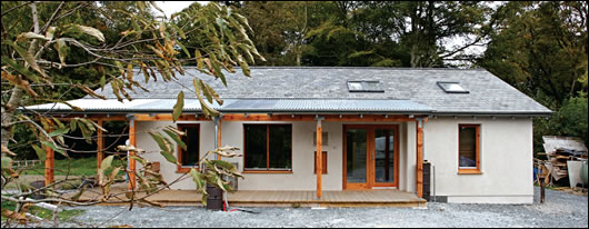The porch is protected by a galvanised steel roof, which provides shading for the south-facing façade in summer. Woolley says galvanised steel is more environmentally friendly than powder-coated steel The porch is protected by a galvanised steel roof, which provides shading for the south-facing façade in summer. Woolley says galvanised steel is more environmentally friendly than powder-coated steel
